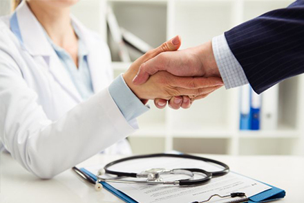 Doctor shaking hands with man in suit
