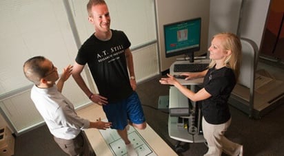 Image of ATSU kinesiology professor demonstrating ankle supination for kinesiology student